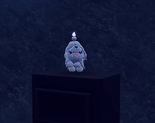 a stuffed animal with a candle on top of it 's head