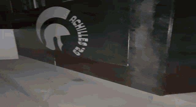 a sign that says achilles on it with smoke coming out of it
