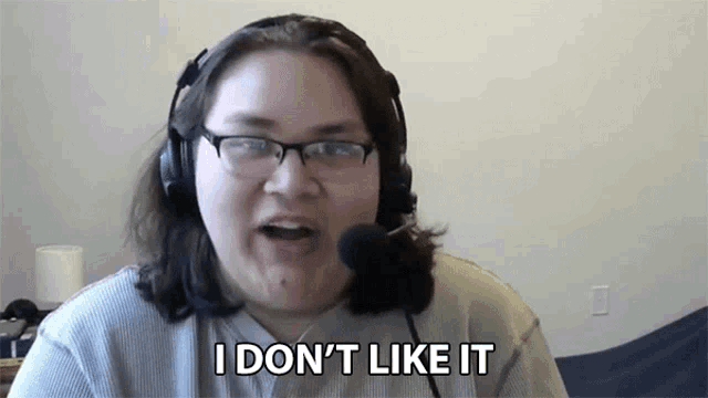 a woman wearing glasses and headphones is saying i don 't like it