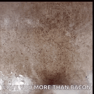a picture of a marble counter top with the words `` love you more than bacon '' written on it .
