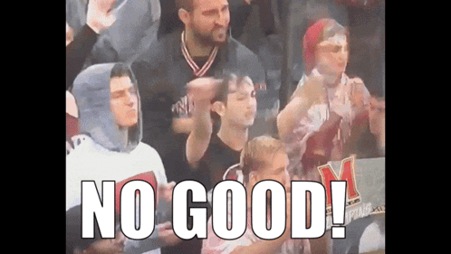a group of people sitting in a stadium with the words " no good " on the screen