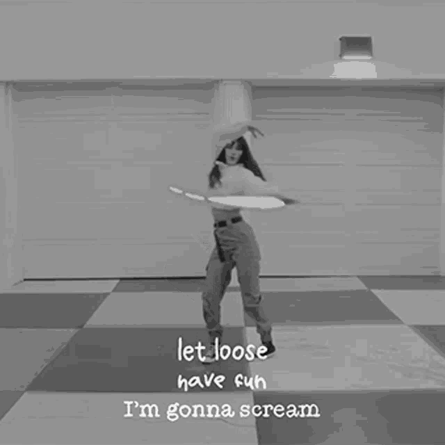 a black and white photo of a girl dancing with the words let loose have fun i 'm gonna scream