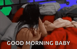 a woman is laying on a bed with a baby and the words `` good morning baby '' written on the bottom .