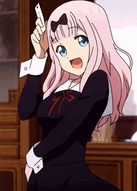 a cartoon girl with pink hair and blue eyes is holding a piece of paper