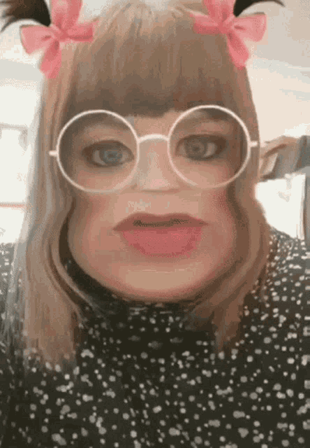 a woman wearing glasses and pigtails looks like a doll