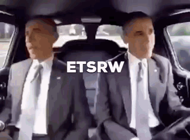 two men in suits and ties are sitting in a car with the word etsrw above them .