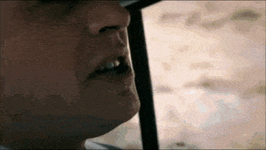 a close up of a person 's face with a blurred background