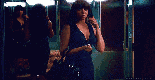 a woman in a blue dress is standing in front of a mirror with the words magician tumblr written below her