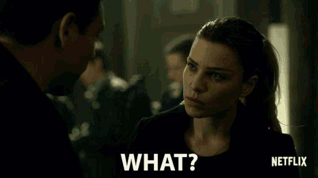 a man and a woman are looking at each other and the woman is saying what