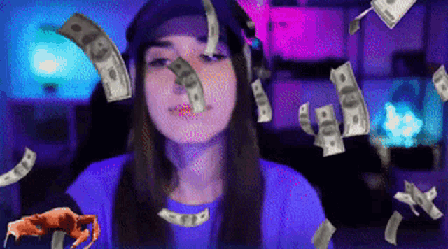 a woman in a blue shirt with money falling around her