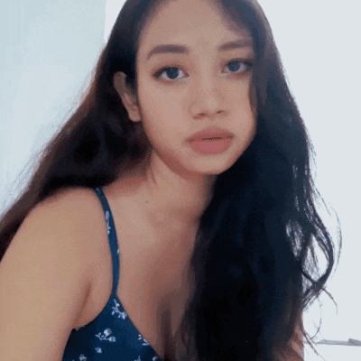 a woman with long dark hair is wearing a blue floral bra