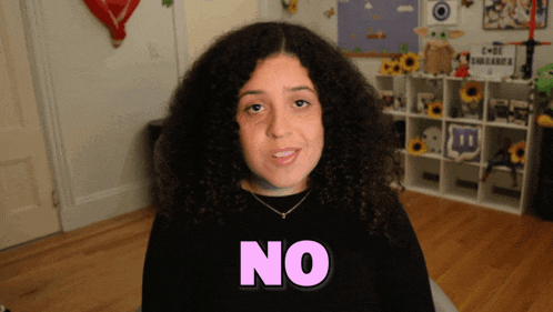 a woman with curly hair says " no " in pink