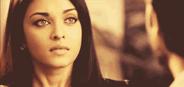 a woman with a serious look on her face looks at the camera