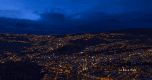 a photo of a city at night with the words la tour at night