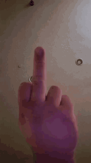 a close up of a person 's hand with purple nails