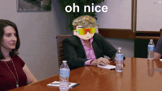 a group of people are sitting at a table with bottles of water and a man wearing sunglasses says oh nice