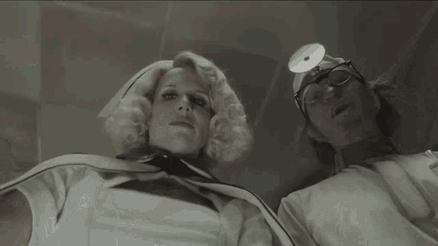 a nurse and a doctor are posing for a photo