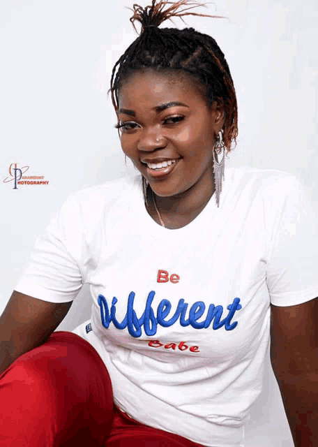 a woman is wearing a white shirt that says be different babe