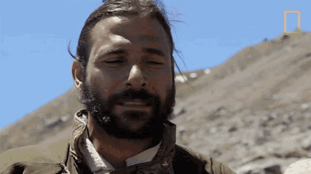 a man with a beard and a national geographic logo on the bottom
