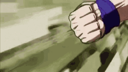 a close up of a person 's fist with a blue wristband .