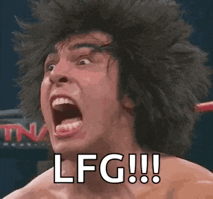 a man with a wig on is screaming in a wrestling ring .