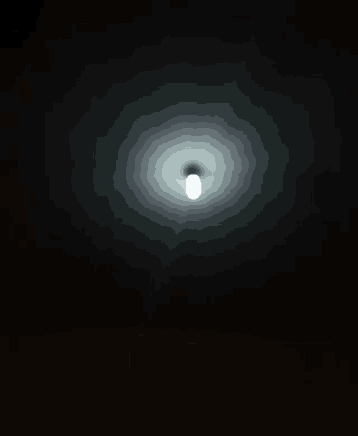 a light bulb is shining in the dark