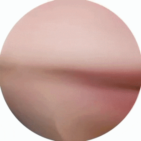 a close up of a pink circle with a blurred background .