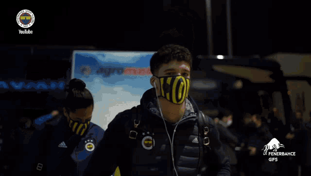 a man wearing a face mask that says ko on it