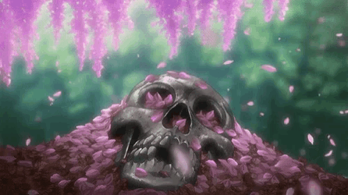 a skull is sitting on top of a pile of pink petals .