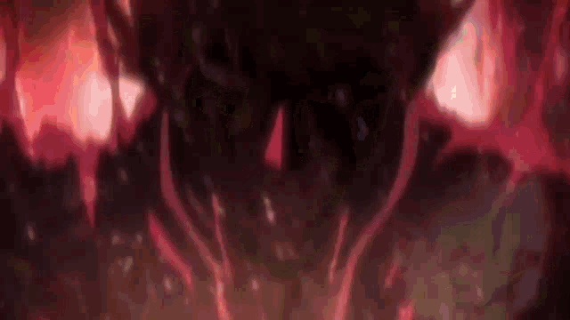a close up of a red and black background with a lot of fire coming out of it