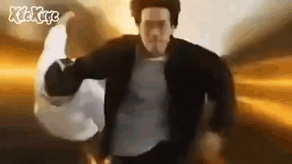 a man in a black jacket is holding a white bag in his hand .