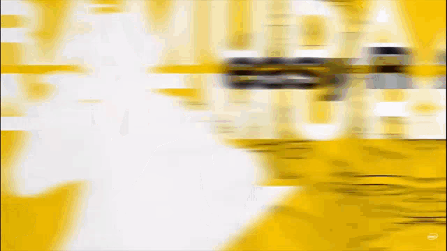 a blurred image of a yellow and white background with a few letters on it