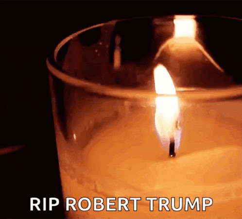a lit candle in a glass with the words rip robert trump written on the bottom