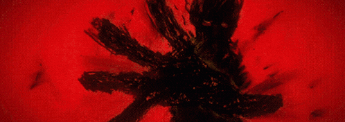 a painting of a red and black flower with the letter m in the middle