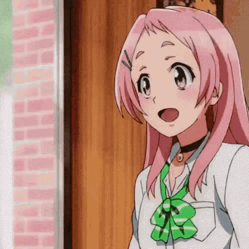 a girl with pink hair and a green tie is standing in front of a door .
