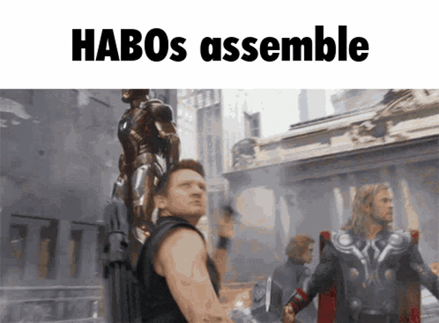 a picture of a man holding a statue with the words habos assemble below it