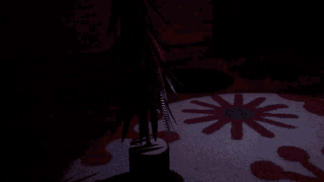 a dark room with a rug with flowers and a circle on it