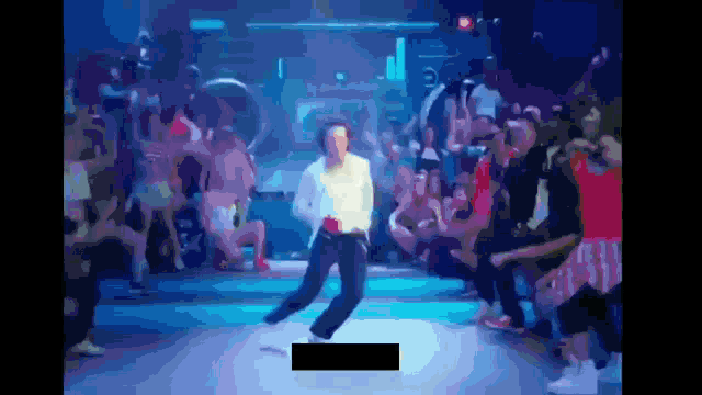 a man is dancing in front of a crowd of people