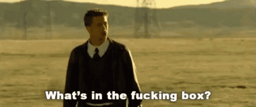 a man in a suit and tie is standing in the middle of a field .