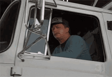 a man in a truck wearing a hat that says ' sd ' on it