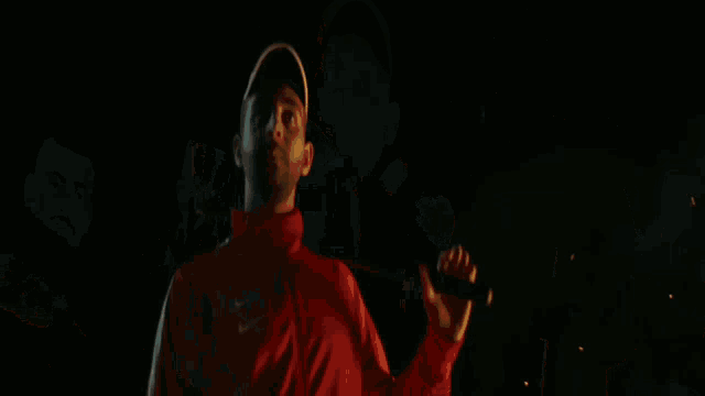 a man in a red nike jacket is standing next to another man