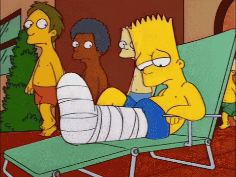 bart simpson has a cast on his leg and is laying on a lounge chair