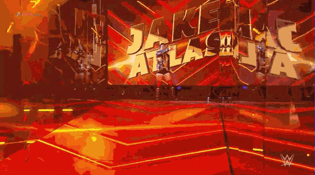 a wrestler named jake atlas is walking on a stage