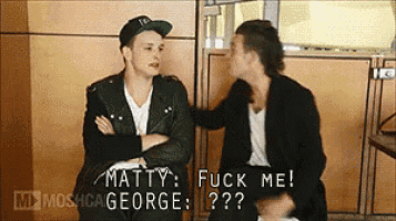 two men are sitting next to each other and one of them is saying matty fuck me george