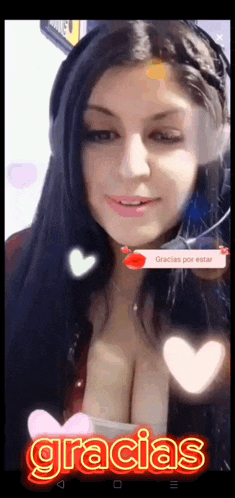 a woman is wearing headphones and smiling with the word gracias on the bottom of the screen