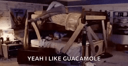 a person is laying on top of a bunk bed in a messy room .