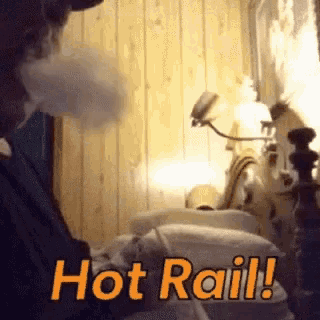 a man is smoking a hookah with the words hot rail written on the bottom
