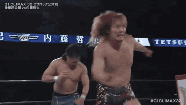 two men are wrestling in a ring with a sign that says # giclimax32