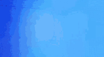 a woman stands in front of a blue wall