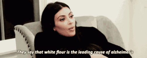 a woman is sitting on a couch and saying that white flour is the leading cause of alzheimer 's